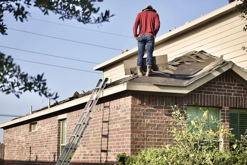 Professional roofer working on a residential roof in Arlington Center
